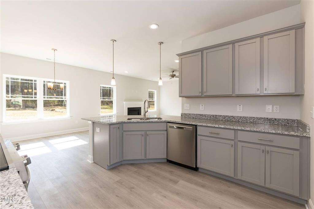 654 Bald Ridge Circle Demorest, GA 30535 - Photo 5 of 22 a kitchen with stainless steel appliances granite countertop a stove a sink and white cabinets with wooden floor