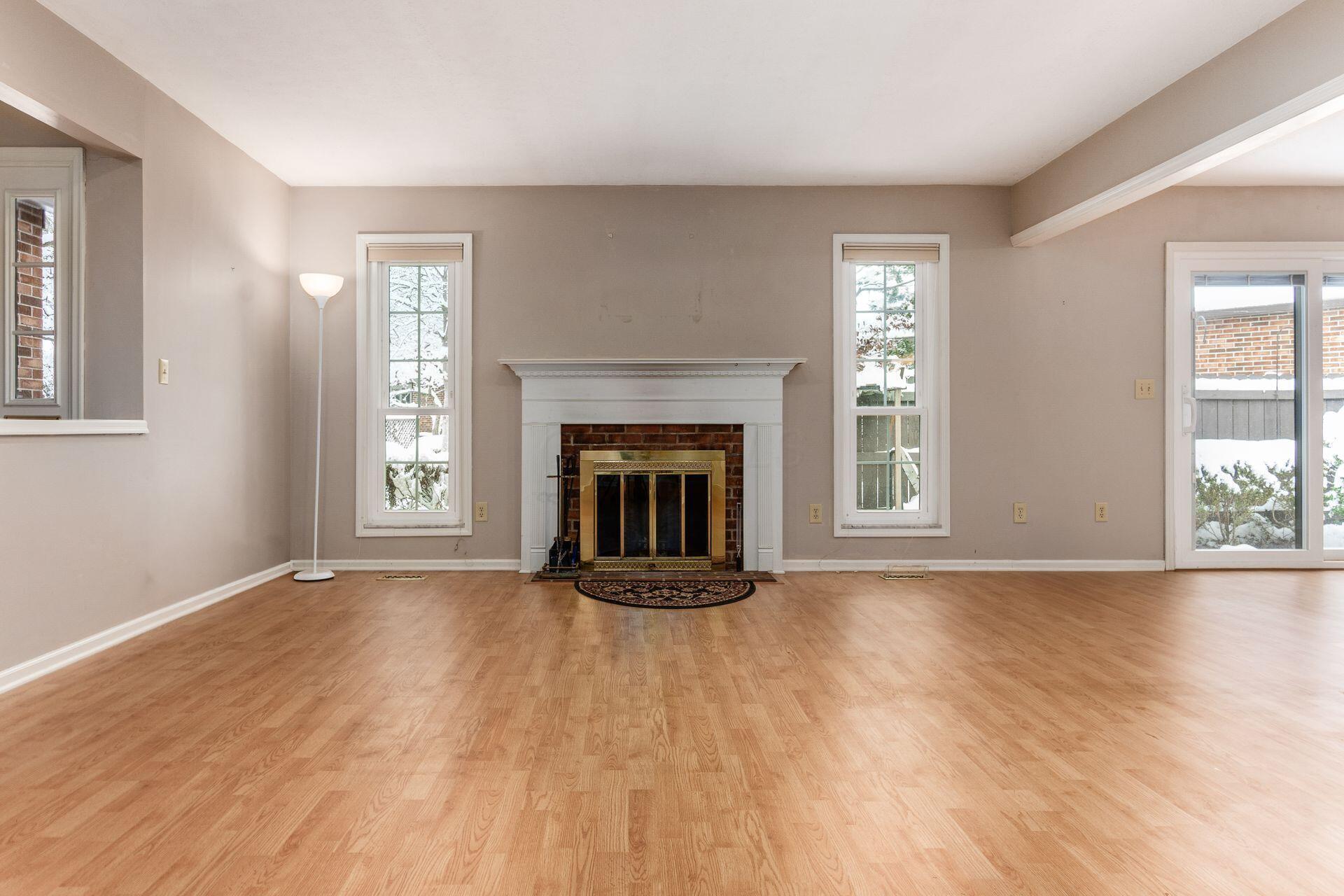 4765 Coach Road Columbus, OH 43220 - Photo 8 of 47 Fireplace framed by floor-to-ceiling windows