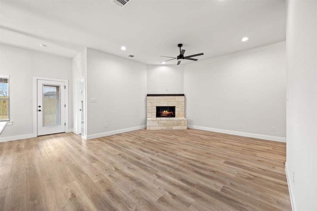 104 Maverick Trail Valley View, TX 76272 - Photo 5 of 30 a view of empty room with wooden floor and fireplace