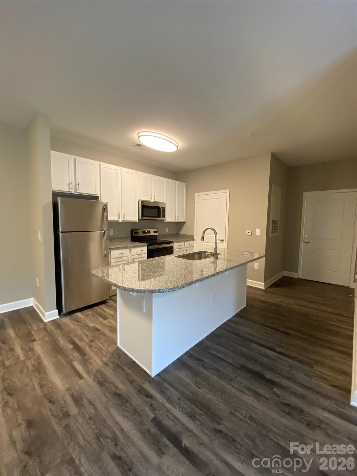 90 Riverside Drive Hickory, NC 28601 - Photo 11 of 15 a large kitchen with kitchen island a sink dishwasher a refrigerator and wooden cabinets