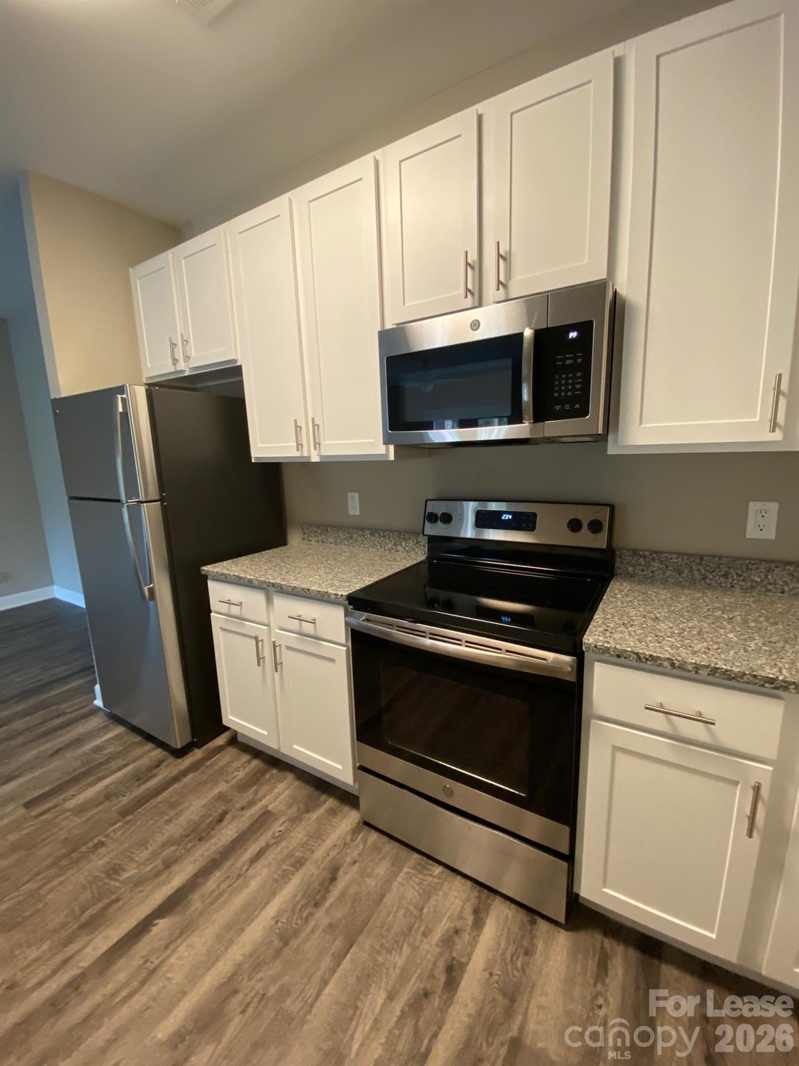 90 Riverside Drive Hickory, NC 28601 - Photo 9 of 15 a kitchen with granite countertop white cabinets and black appliances