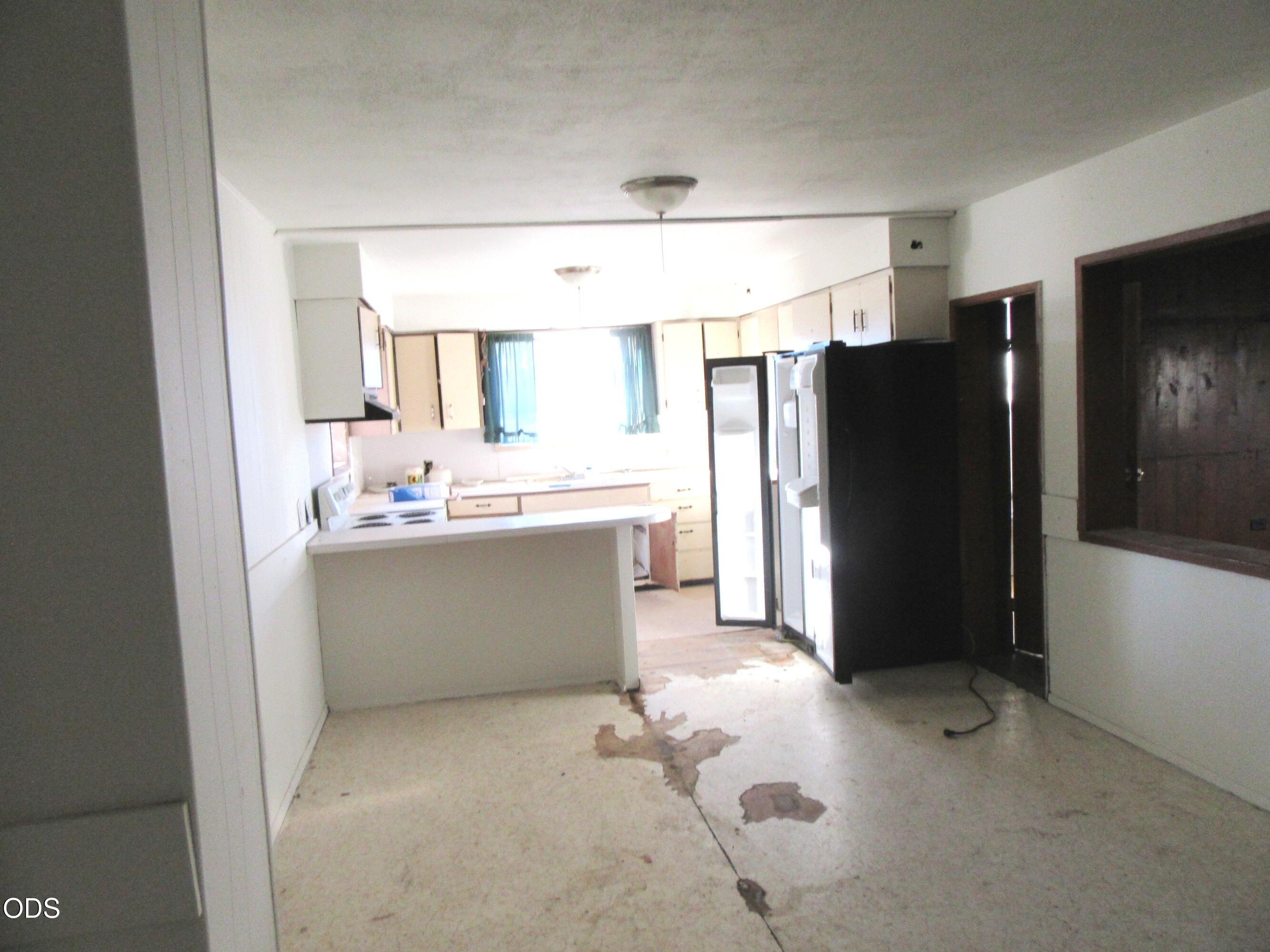 9805 East Langell Valley Road Bonanza, OR 97623 - Photo 16 of 41 a room with a refrigerator and a sink