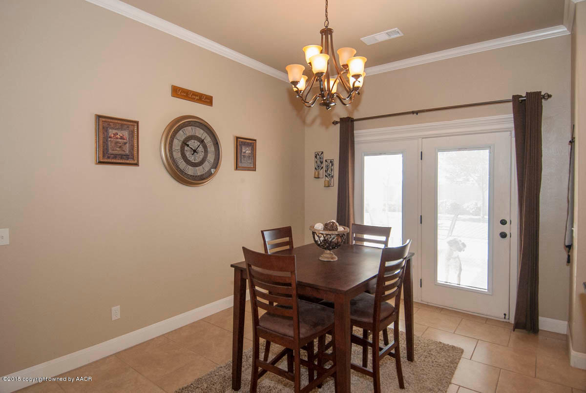 3817 Arden Road Amarillo, TX 79118 - Photo 11 of 30 a dining room with a table and chairs
