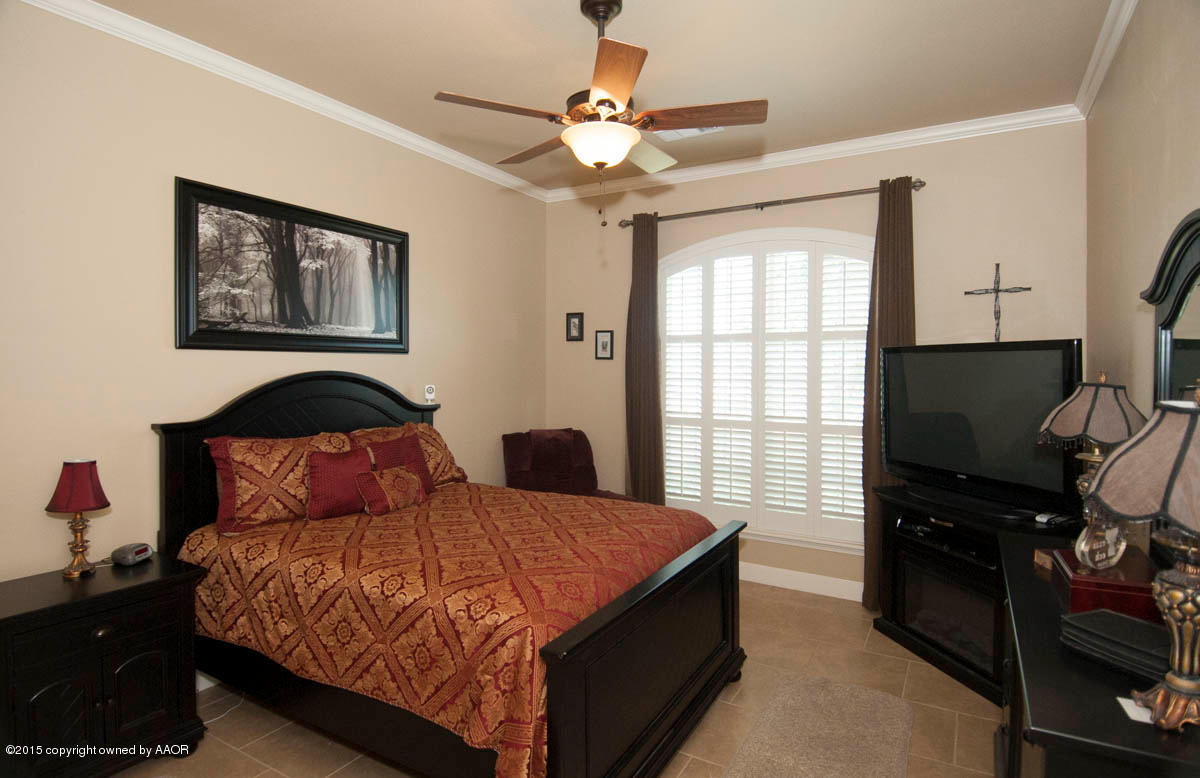 3817 Arden Road Amarillo, TX 79118 - Photo 12 of 30 a bedroom with a bed and a flat screen tv