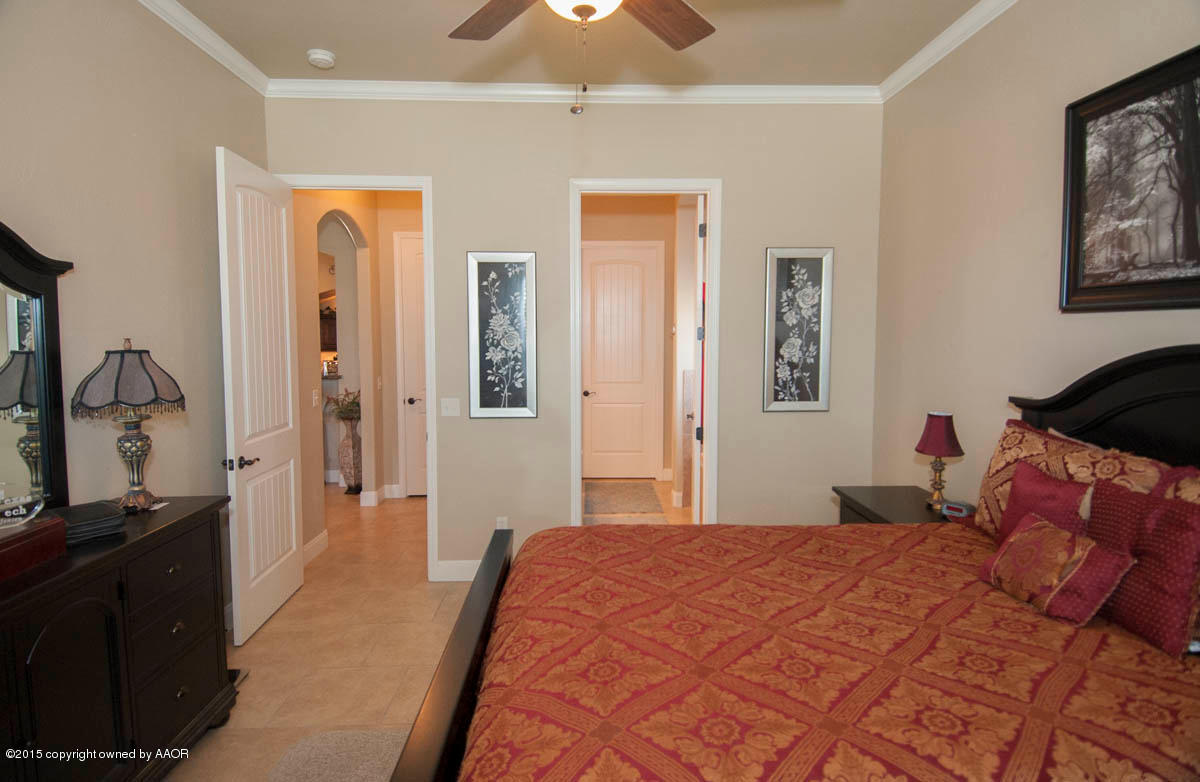 3817 Arden Road Amarillo, TX 79118 - Photo 13 of 30 a bedroom with a bed and a lamp on dresser