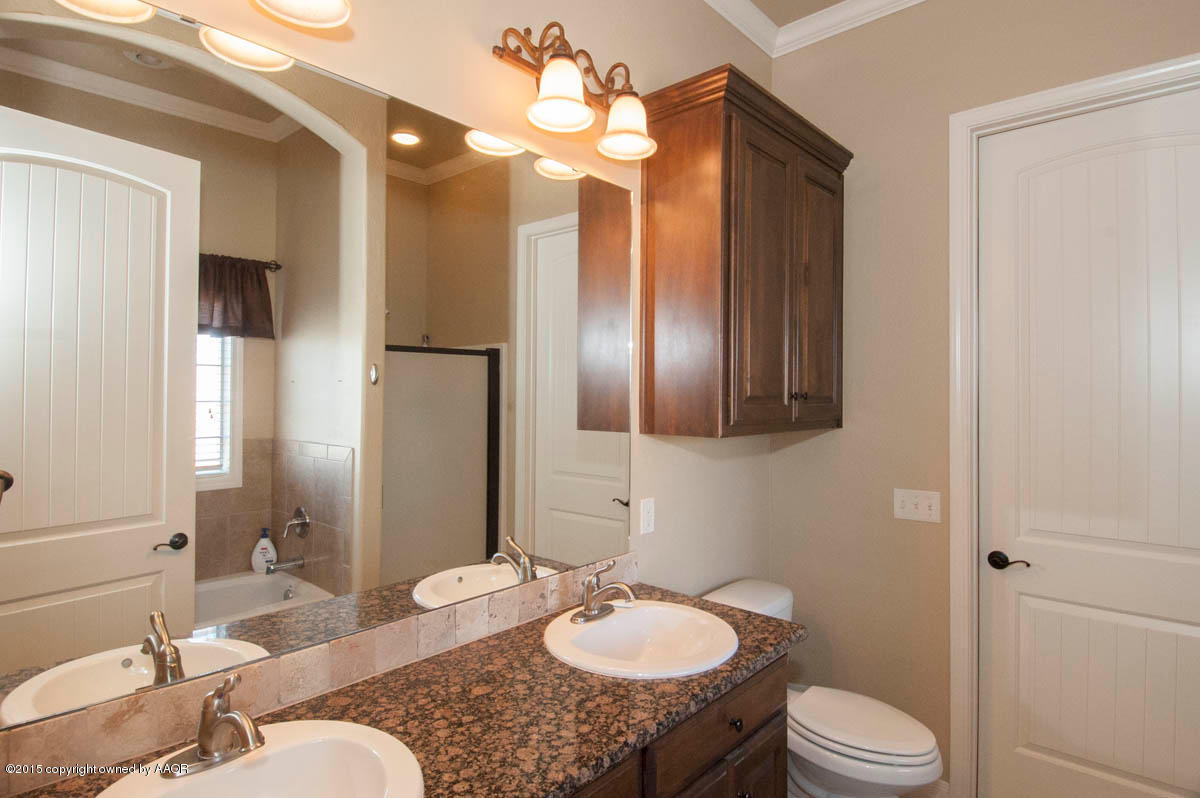 3817 Arden Road Amarillo, TX 79118 - Photo 14 of 30 a bathroom with a granite countertop sink and a mirror