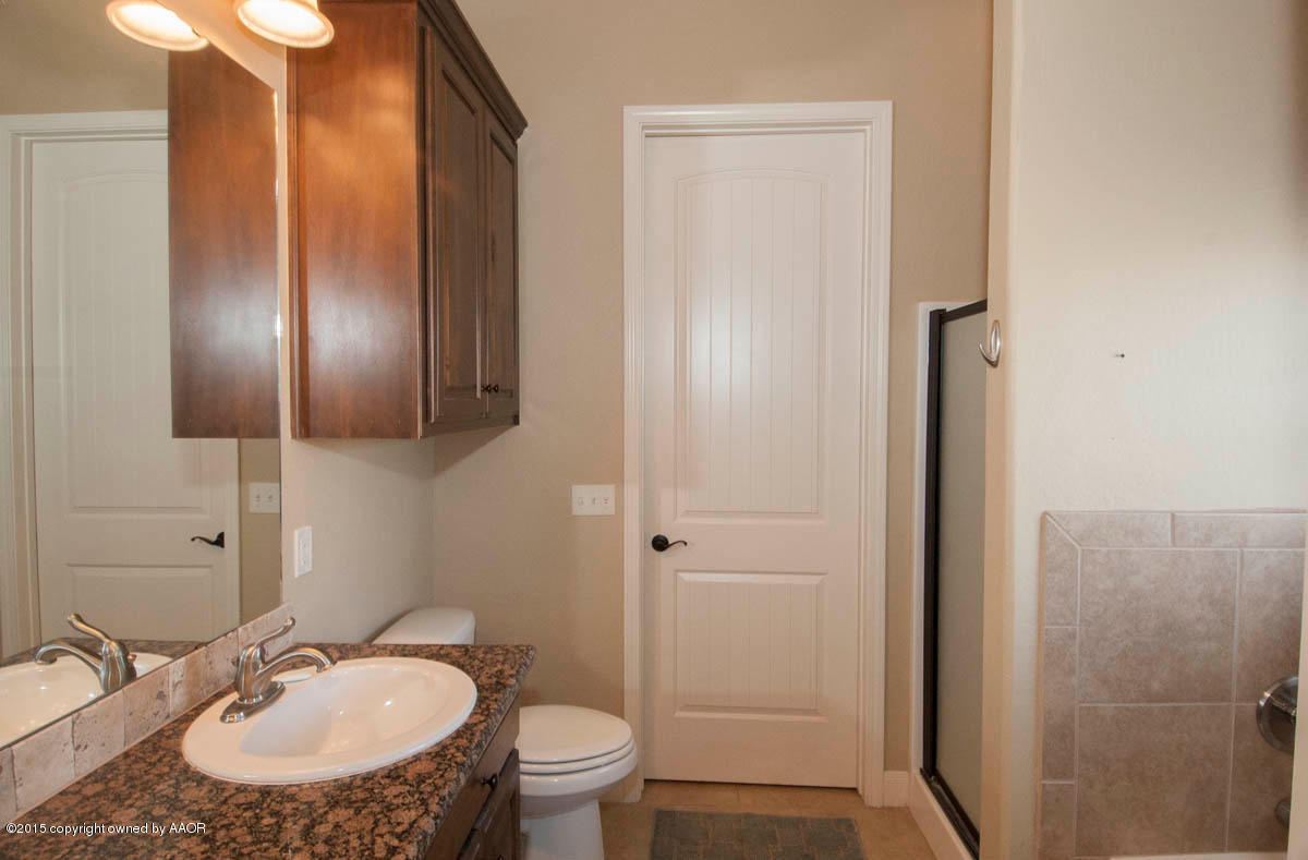 3817 Arden Road Amarillo, TX 79118 - Photo 15 of 30 a bathroom with a sink toilet and shower