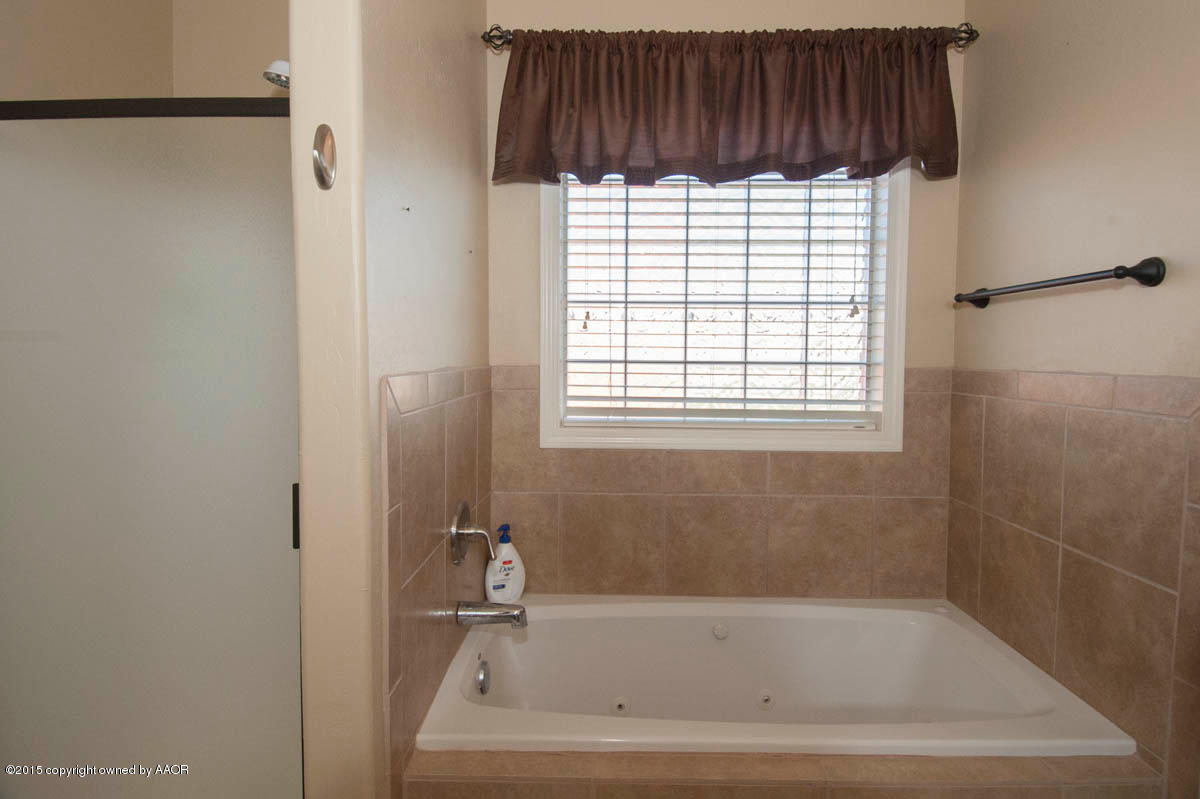 3817 Arden Road Amarillo, TX 79118 - Photo 16 of 30 a bathroom with a bathtub and a shower