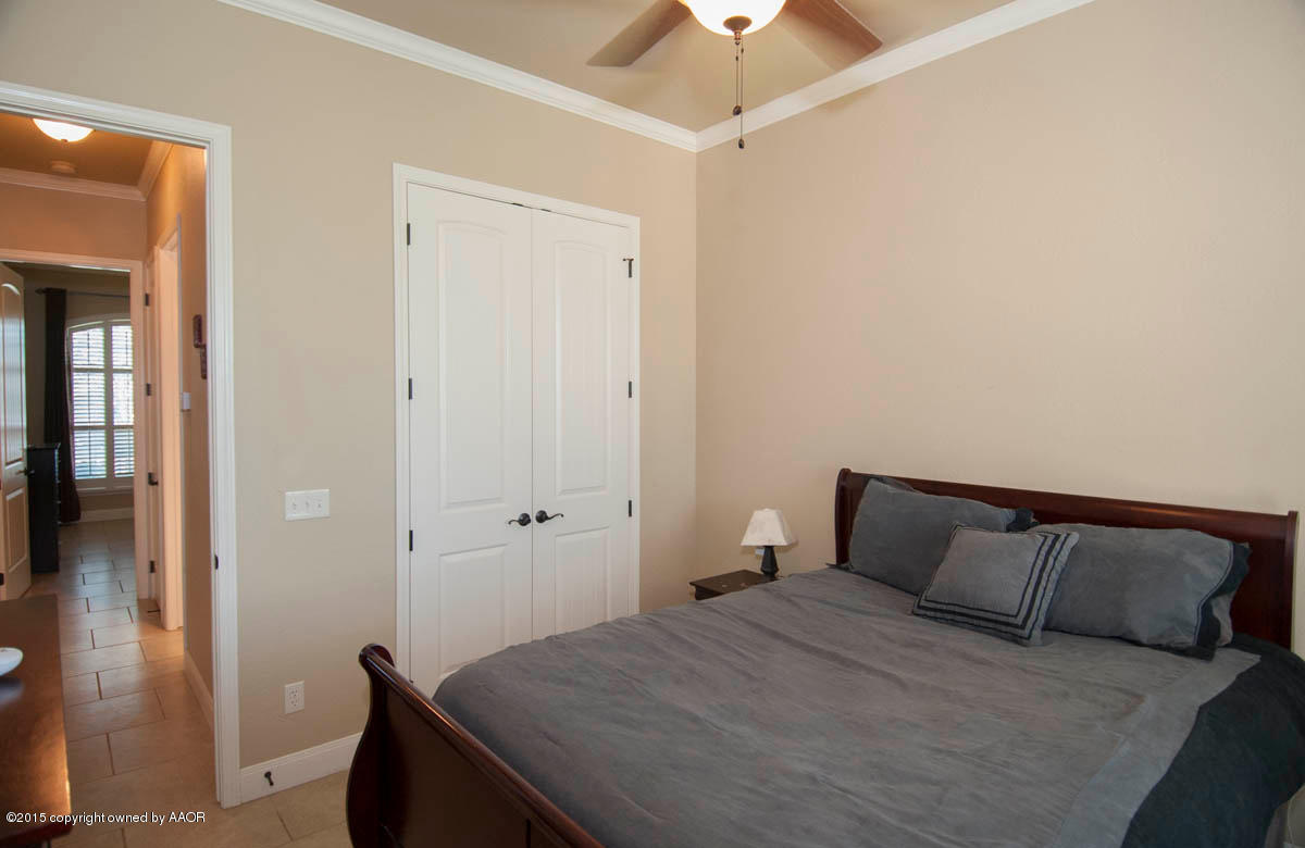 3817 Arden Road Amarillo, TX 79118 - Photo 18 of 30 a bedroom with a bed and a table