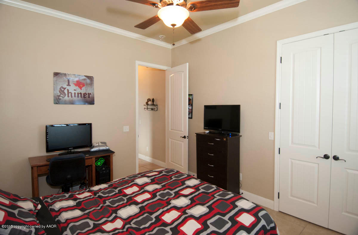 3817 Arden Road Amarillo, TX 79118 - Photo 22 of 30 a bedroom with a bed and a flat screen tv