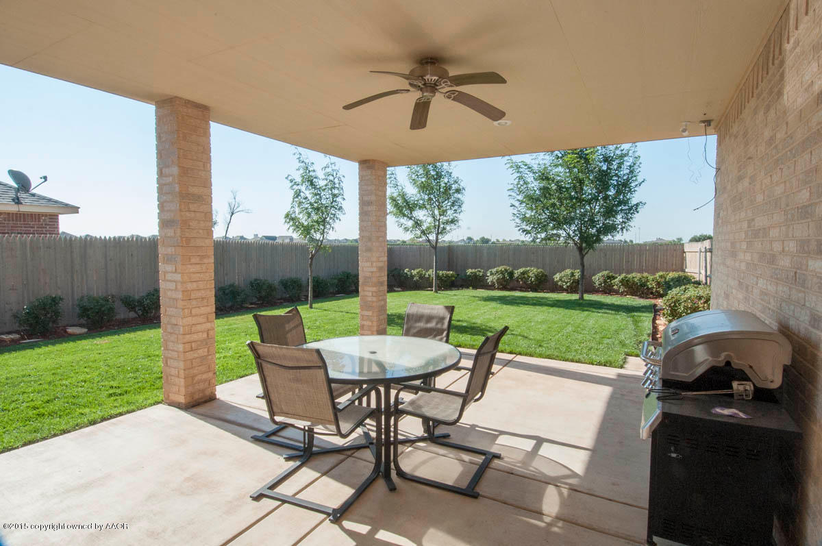 3817 Arden Road Amarillo, TX 79118 - Photo 24 of 30 a view of a patio with a table chairs and a yard