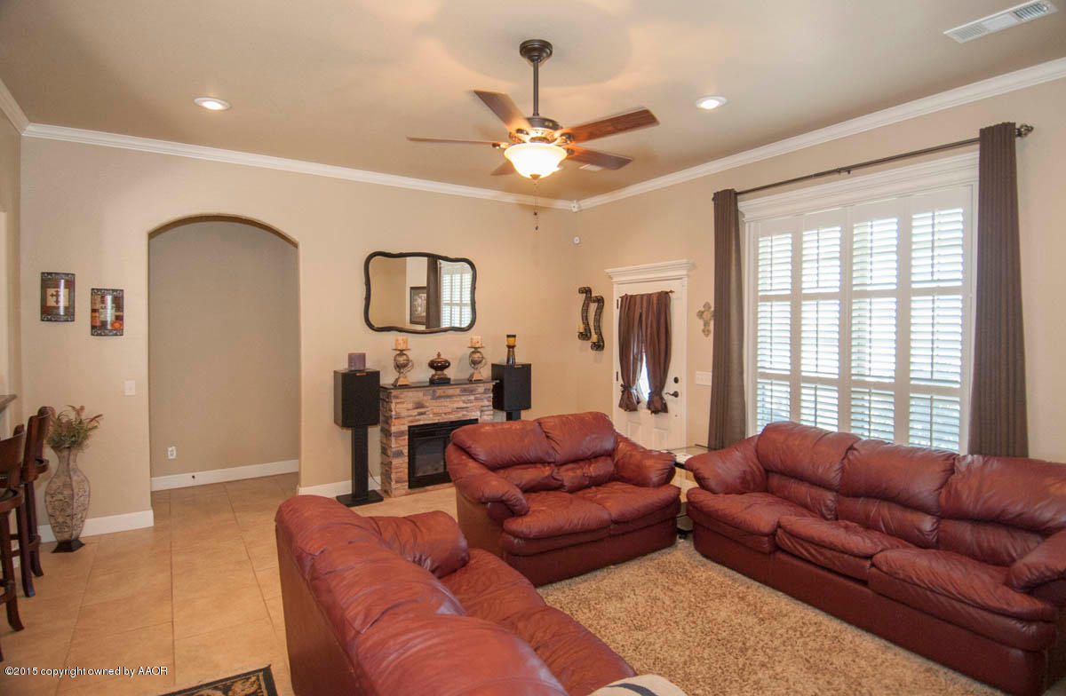 3817 Arden Road Amarillo, TX 79118 - Photo 4 of 30 a living room with furniture a chandelier and a flat screen tv