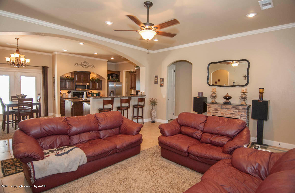3817 Arden Road Amarillo, TX 79118 - Photo 5 of 30 a living room with furniture kitchen view and a chandelier