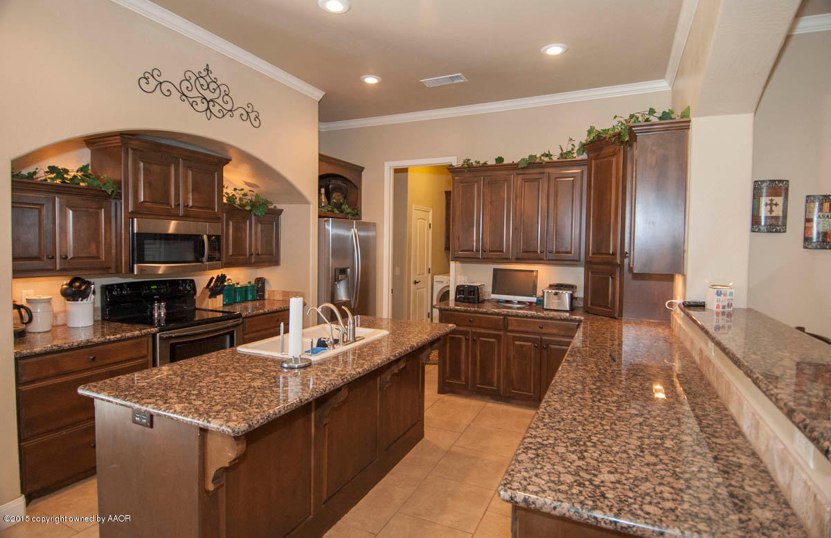 3817 Arden Road Amarillo, TX 79118 - Photo 7 of 30 a large kitchen with stainless steel appliances granite countertop a stove and a wooden cabinets