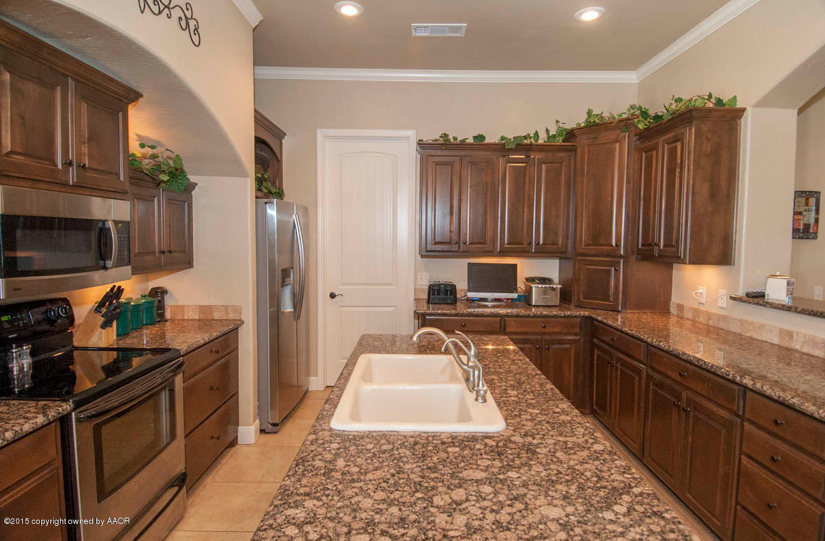 3817 Arden Road Amarillo, TX 79118 - Photo 8 of 30 a kitchen with granite countertop stainless steel appliances and wooden cabinets