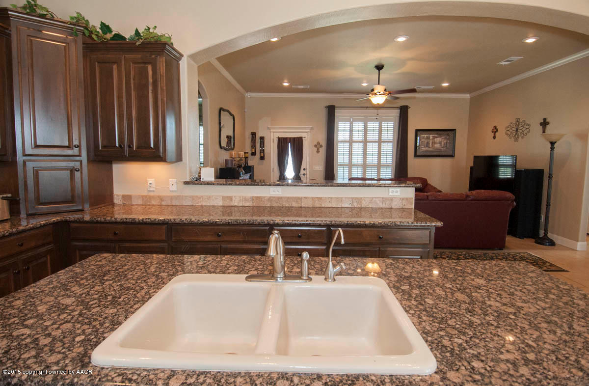 3817 Arden Road Amarillo, TX 79118 - Photo 9 of 30 a kitchen with kitchen island granite countertop a refrigerator and a sink