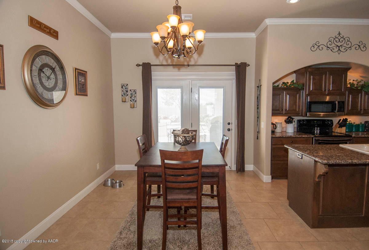 3817 Arden Road Amarillo, TX 79118 - Photo 10 of 30 a dining room with a wooden table and chairs