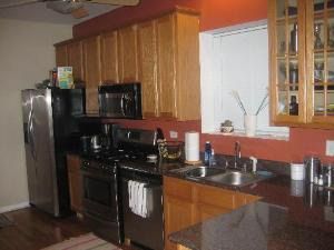 4451 South Indiana Avenue, Unit 2S Chicago, IL 60653 - Photo 3 of 4 a kitchen with stainless steel appliances a sink stove and refrigerator