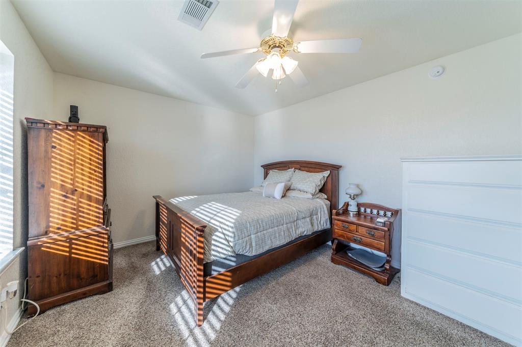 20175 Willow Glade Circle Pilot Point, TX 76258 - Photo 21 of 32 Carpeted bedroom with ceiling fan
