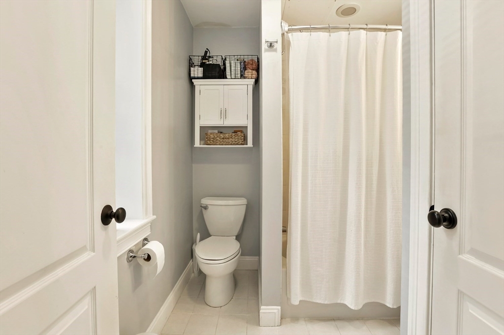 454 Hanover Street, Unit 4 Boston, MA 02113 - Photo 19 of 23 a white toilet sitting next to a bathroom sink