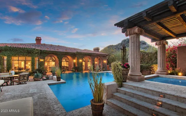 a view of a swimming pool with outdoor seating