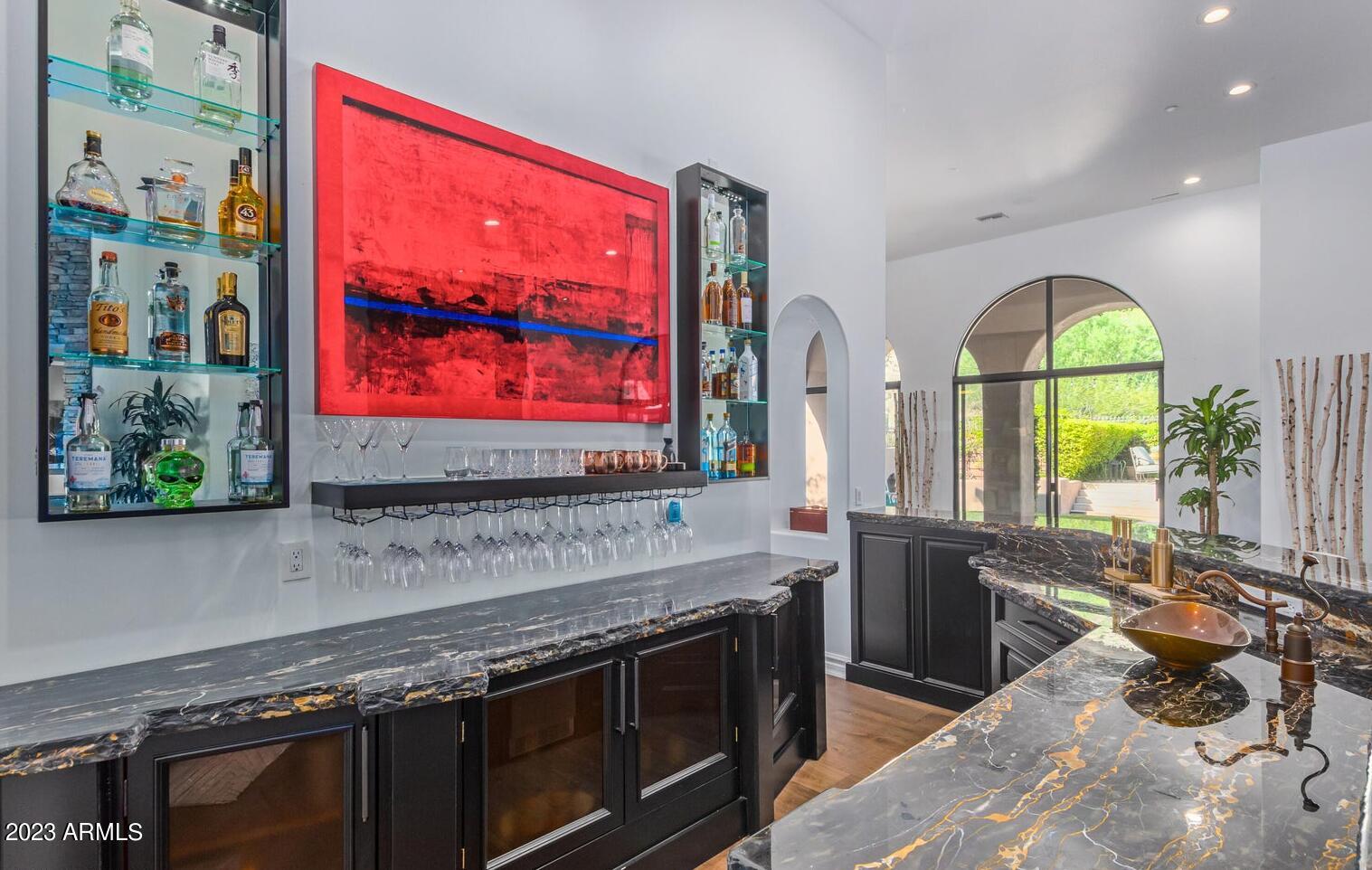 16469 North 113th Way Scottsdale, AZ 85255 - Photo 14 of 47 a kitchen with stainless steel appliances granite countertop a stove a sink and a microwave