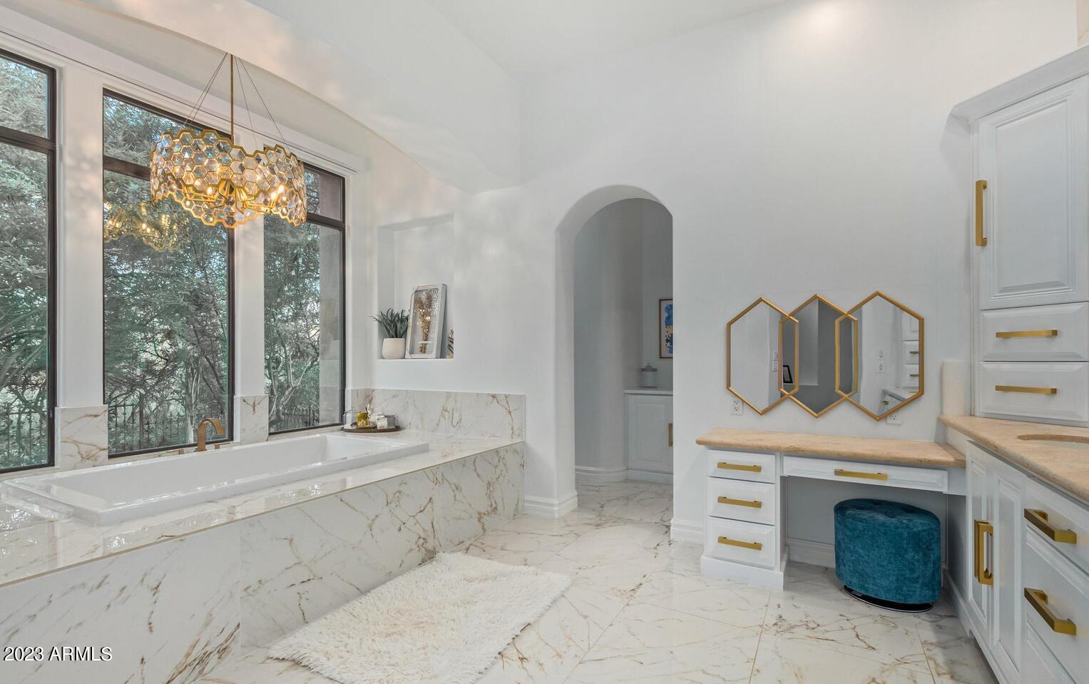 16469 North 113th Way Scottsdale, AZ 85255 - Photo 23 of 47 a spacious bathroom with a bathtub sink and mirror