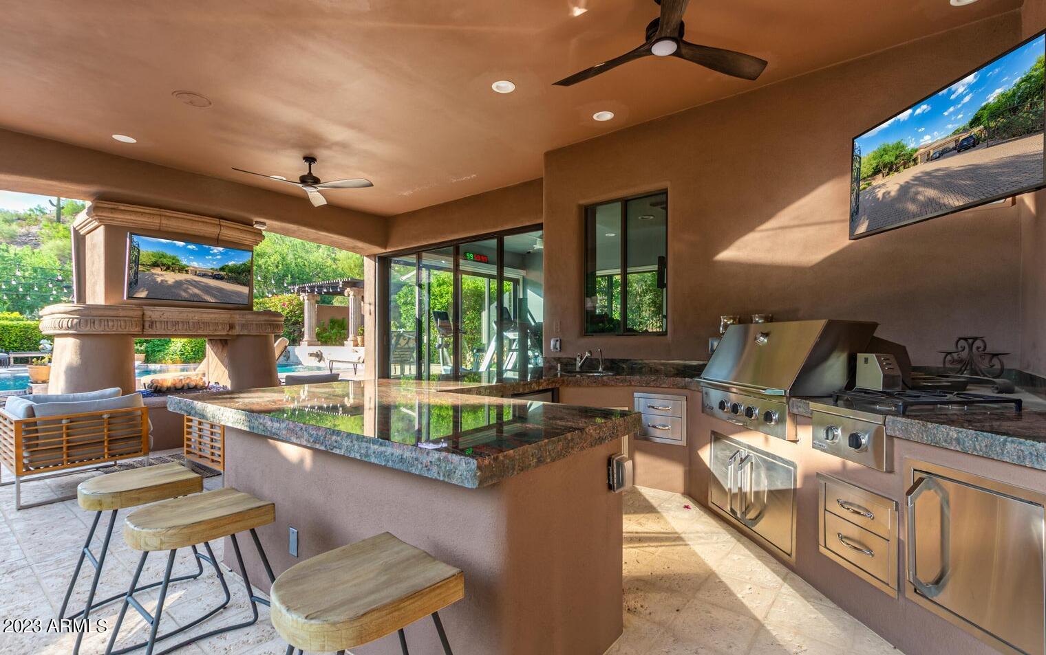 16469 North 113th Way Scottsdale, AZ 85255 - Photo 26 of 47 a living room with furniture a floor to ceiling window and outdoor view