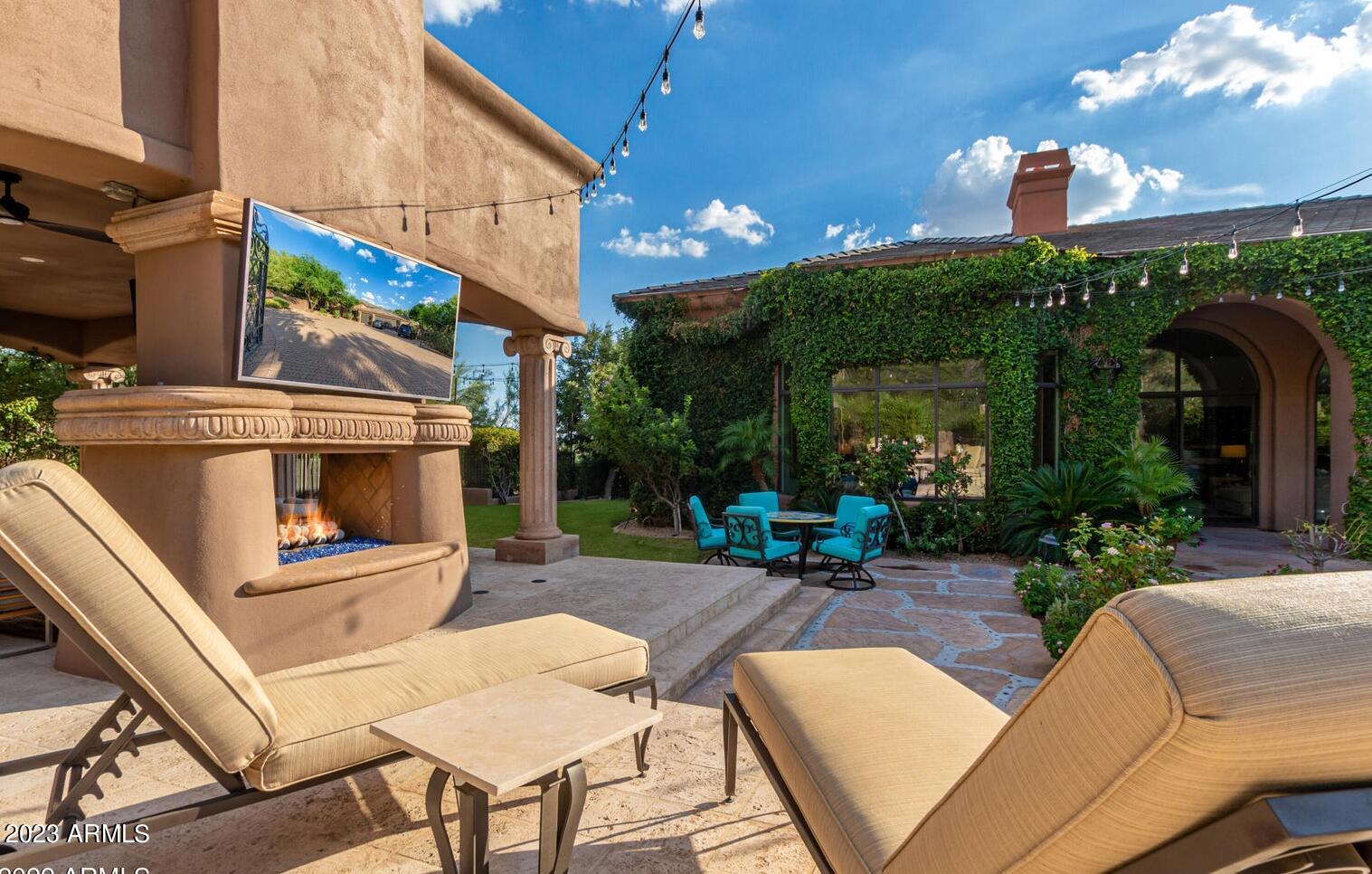 16469 North 113th Way Scottsdale, AZ 85255 - Photo 27 of 47 a view of a patio with a table and chairs under an umbrella