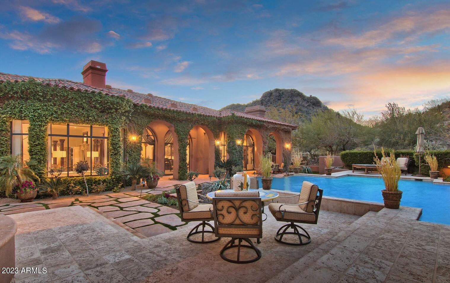 16469 North 113th Way Scottsdale, AZ 85255 - Photo 30 of 47 a view of a patio with dining table and chairs with a fire pit