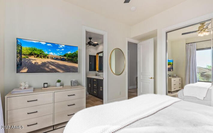 16469 North 113th Way Scottsdale, AZ 85255 - Photo 38 of 47 a bedroom with a bed and a flat screen tv