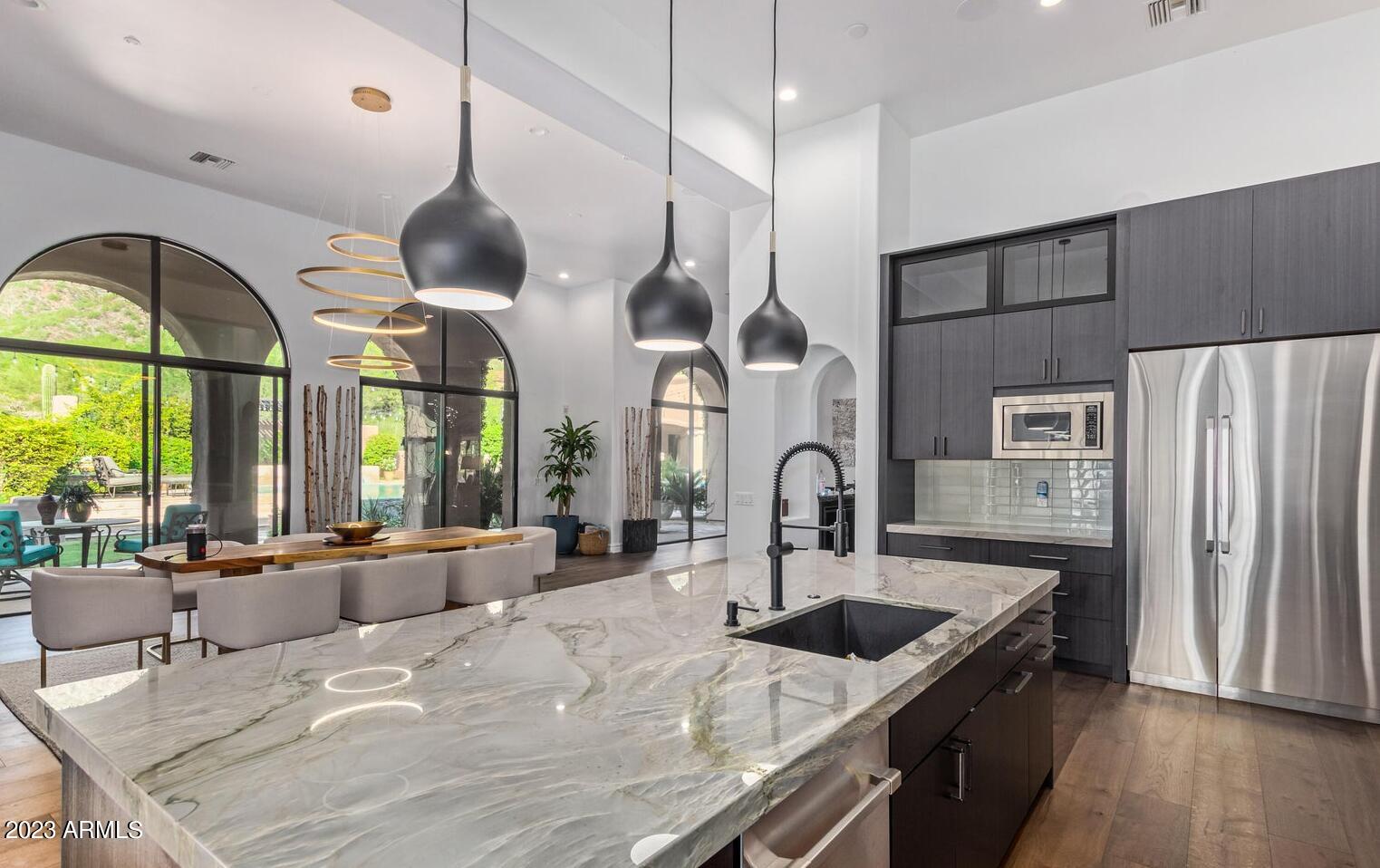 16469 North 113th Way Scottsdale, AZ 85255 - Photo 4 of 47 a kitchen with stainless steel appliances granite countertop a sink a stove and a refrigerator