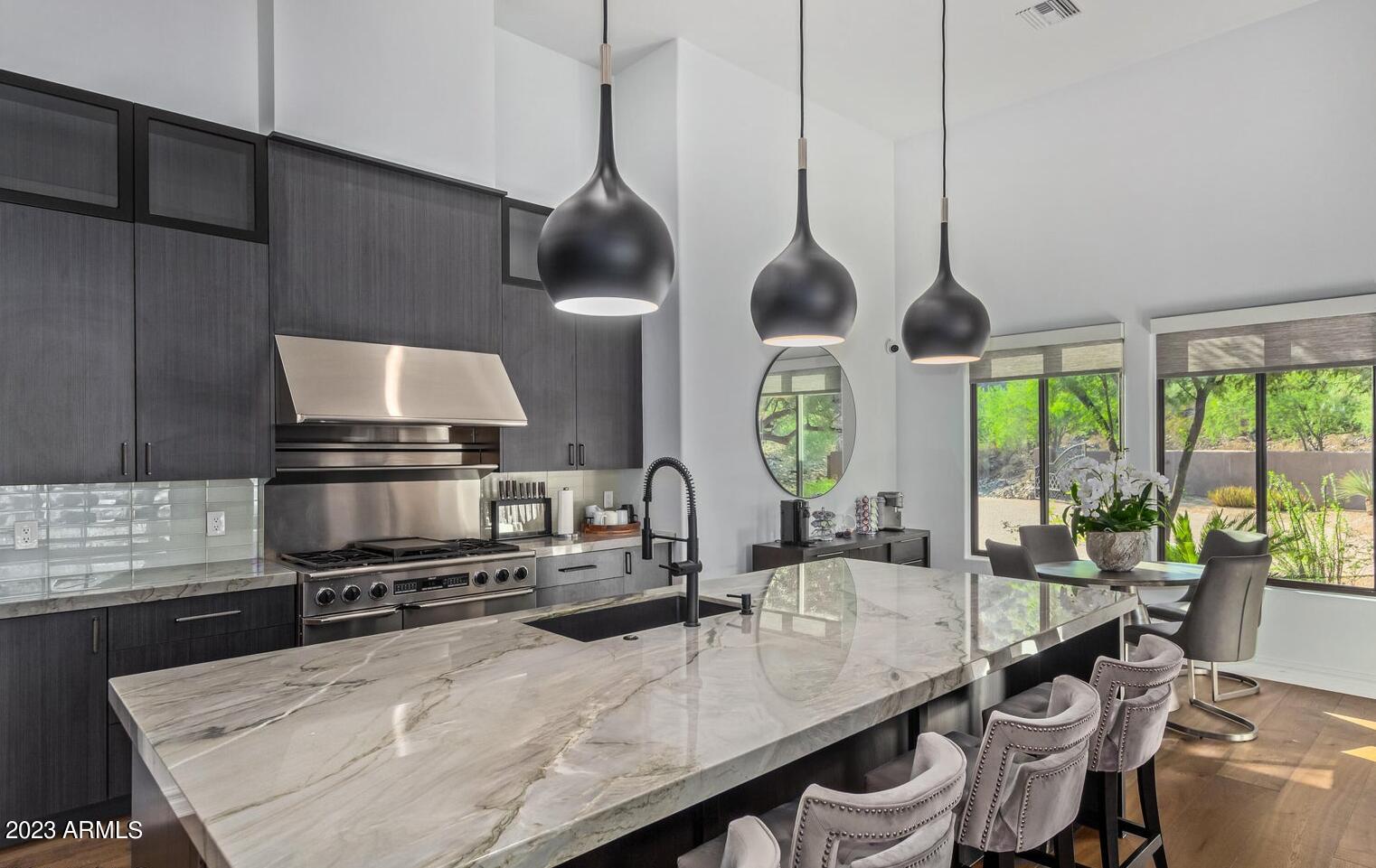 16469 North 113th Way Scottsdale, AZ 85255 - Photo 5 of 47 a kitchen with stainless steel appliances granite countertop a sink a stove and a wooden floors