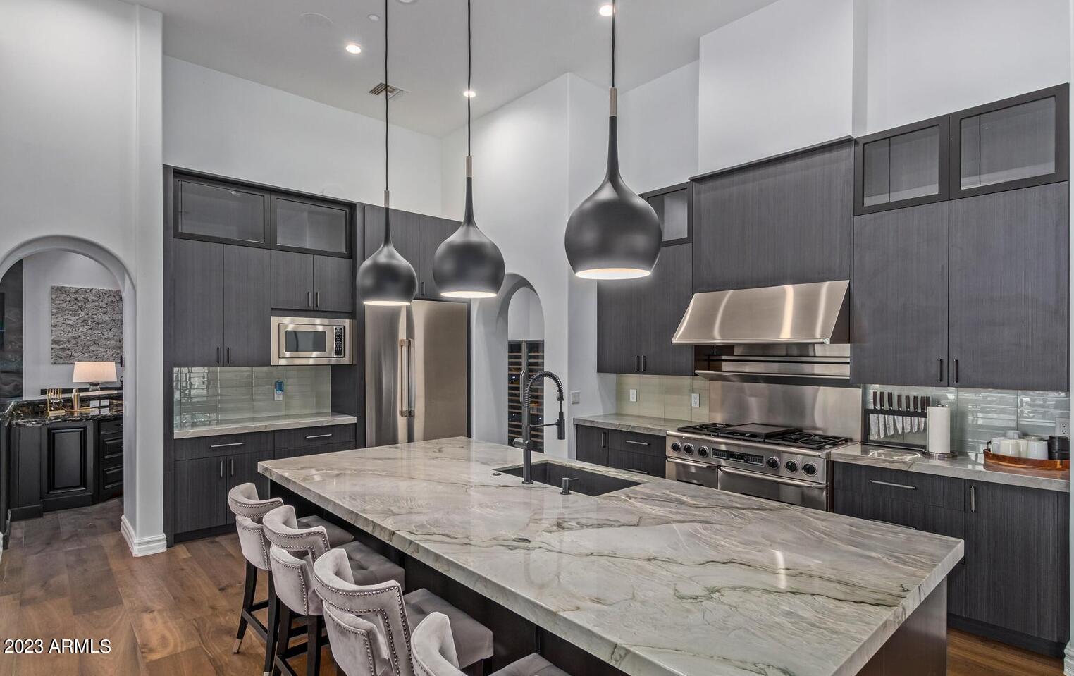 16469 North 113th Way Scottsdale, AZ 85255 - Photo 6 of 47 a kitchen with stainless steel appliances granite countertop a sink a stove and refrigerator