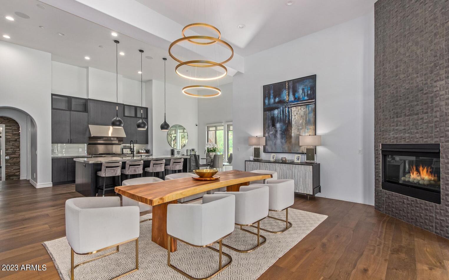 16469 North 113th Way Scottsdale, AZ 85255 - Photo 10 of 47 a room with stainless steel appliances a stove a kitchen island a dining table and chairs