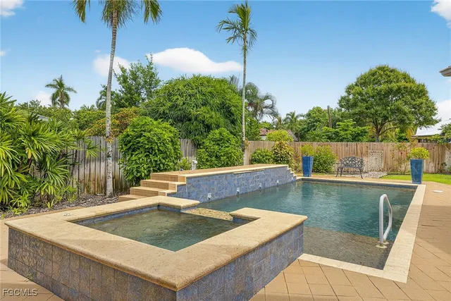 a view of swimming pool with a bench in patio