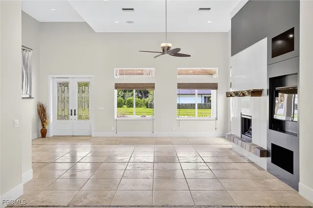 a living room with furniture a fireplace and a potted plant
