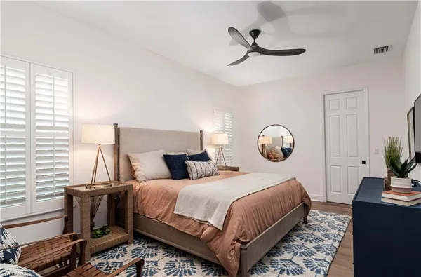a bedroom with a bed and a chandelier
