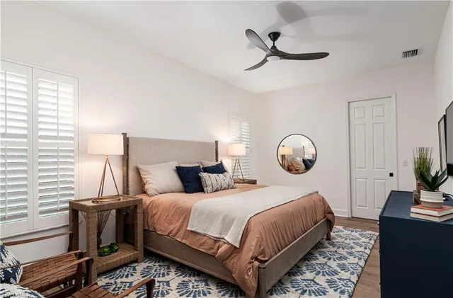 a bedroom with a bed and a chandelier