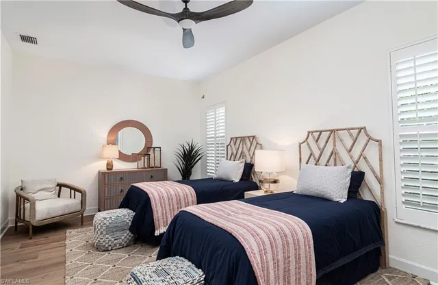 a bedroom with two beds and a couch