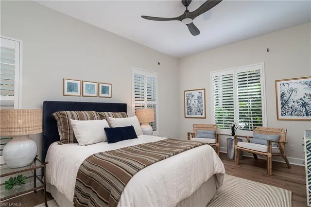 a bedroom with a bed a chair and a window