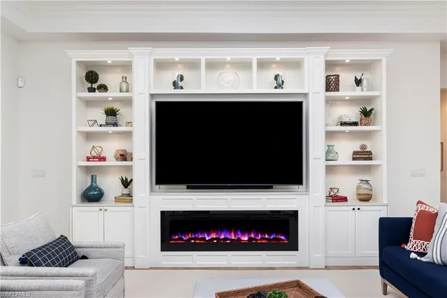a living room with a fireplace and a flat screen tv