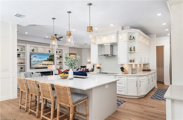 a view of a kitchen and living room with a dining table chairs