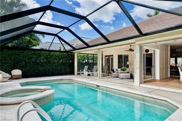 a swimming pool with outdoor seating and yard