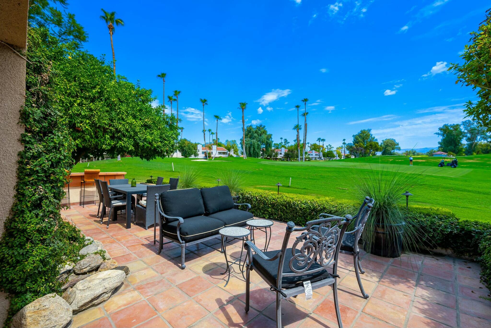 38 Mission Court Rancho Mirage, CA 92270 - Photo 48 of 61 a view of a chairs and table in the garden