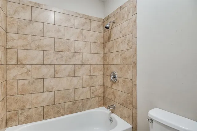 a bathroom with a bathtub and toilet