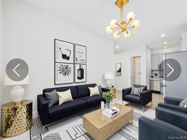a living room with furniture a chandelier and a window