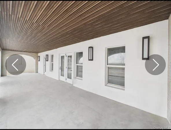 a view of an empty room with window and cabinet