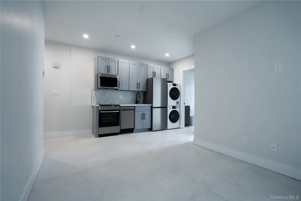 a kitchen with stainless steel appliances a refrigerator sink and stove