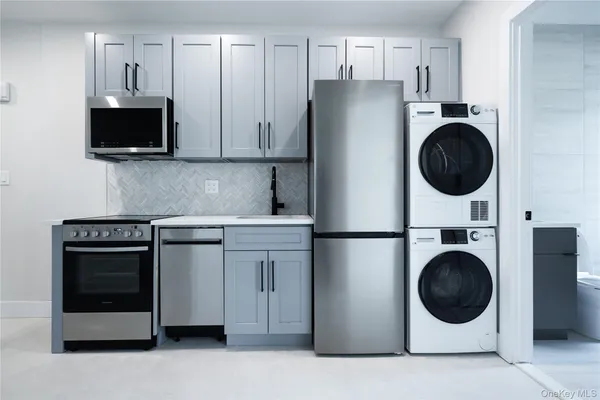 a kitchen with stainless steel appliances a white stove top oven and refrigerator